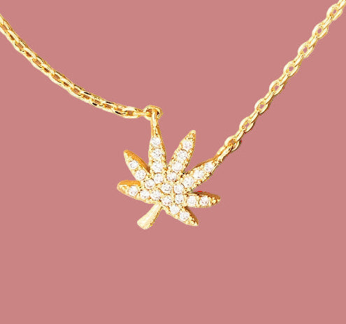 Gold necklace with a leaf pendant on a coin, Must Have